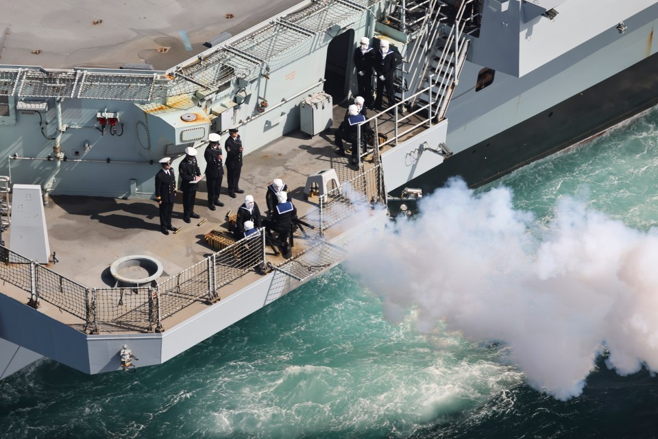 An aerial view of the 96 gun salute, taken from a Merlin Mk2 helicopter of 820 Naval Air Squadron embarked on board HMS Queen Elizabeth