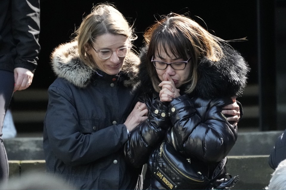 Another woman clasped her hands together after paying tribute to Her Majesty