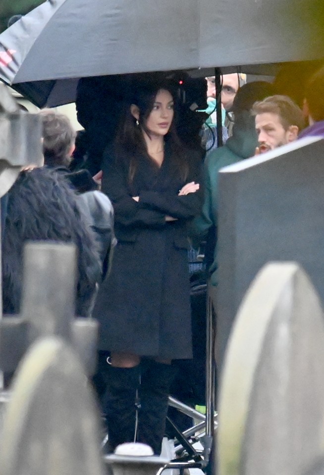 Michelle sheltered under a huge umbrella as she took a break from scenes as Erin Croft