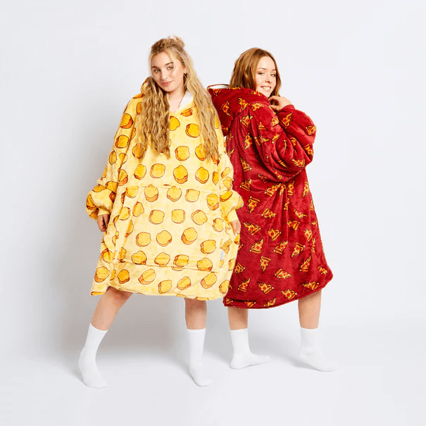 two women wearing blankets with potatoes on them