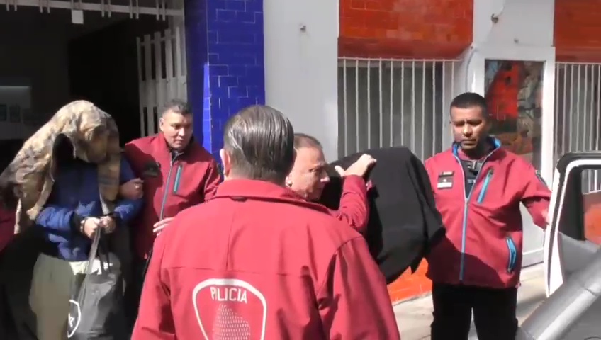 The pair were bundled out of the police station to be taken to the prosecutor's office