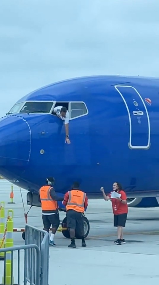The pilot had to lean out of the window to get the phone from ground staff