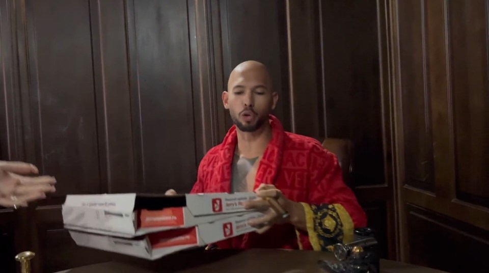 Tate posted a bizarre video in which he was handed two pizza boxes
