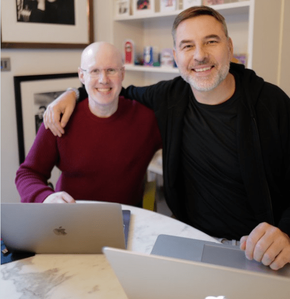The comedians posed together as they worked on their laptops