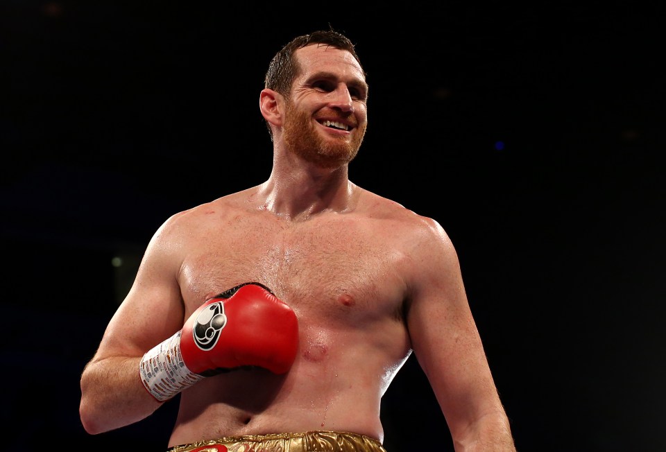 a boxer without a shirt is wearing a pair of red gloves