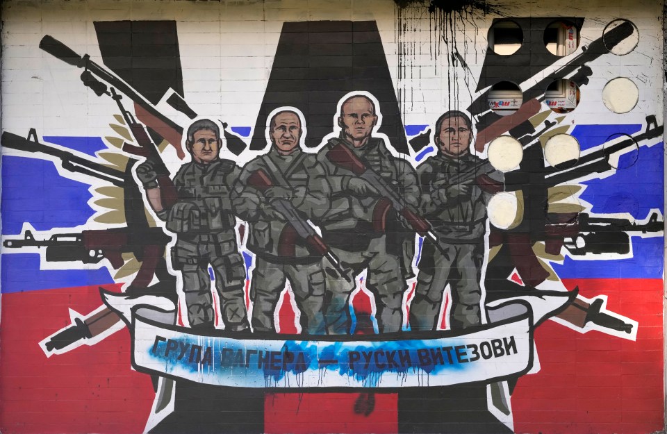 A defaced mural shows the Wagner Group with the words "Russian knights" in Belgrade, Serbia