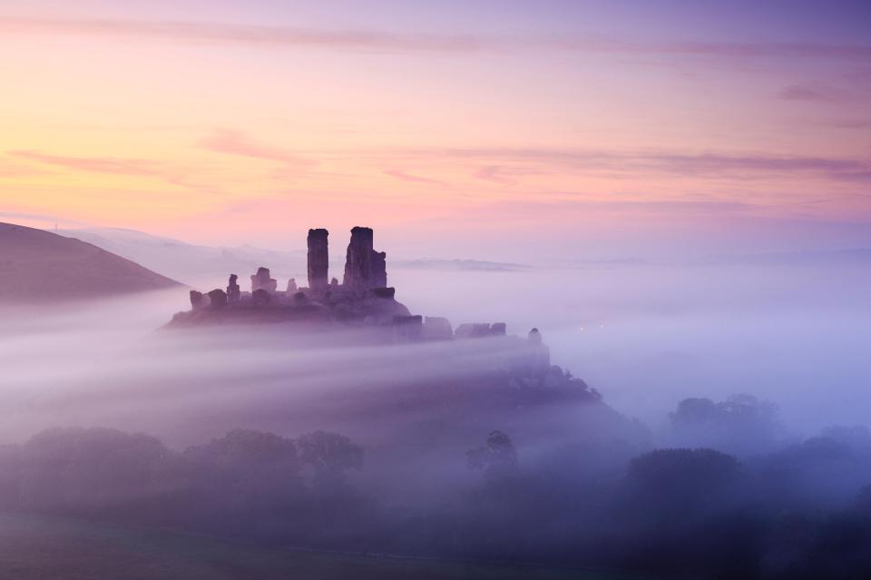 Corfe Castle paints a mysterious picture on the Dorset hills
