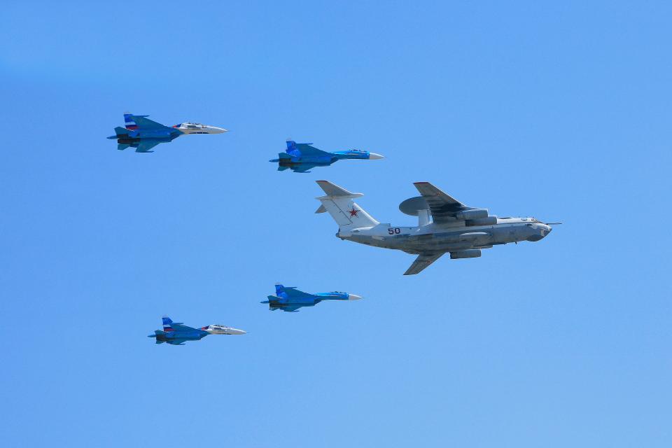 An A-50U flanked by four Su-27 fighters during a Victory Day parade in Moscow