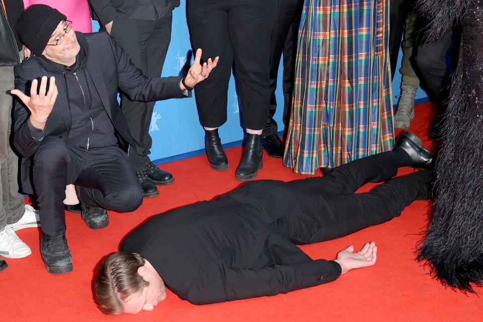 Alexander Skarsgard posed face down on the red carpet at the Berlin premiere of his horror film Infinity Pool