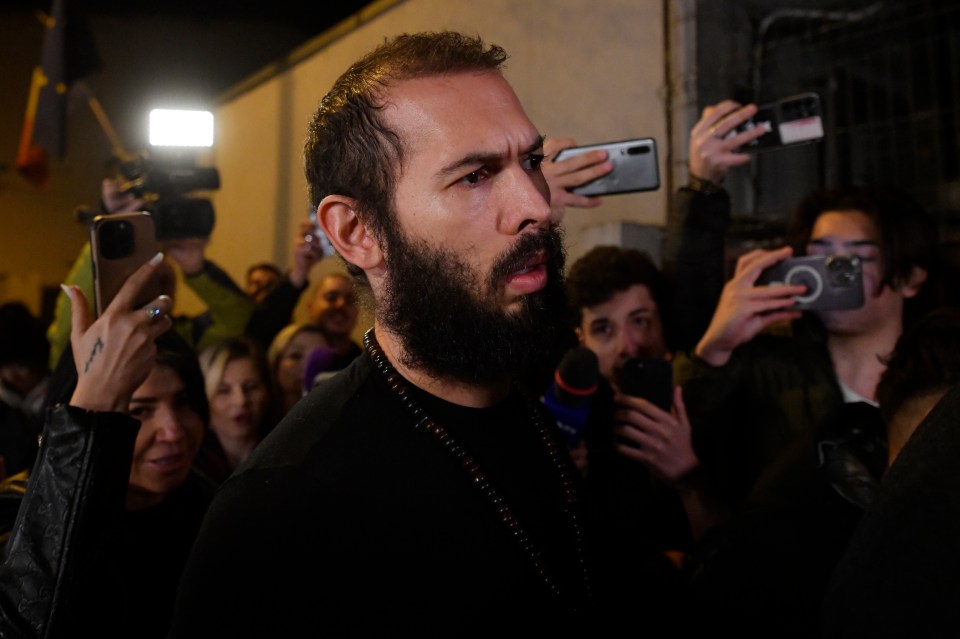 Young fans and media surround Andrew Tate as he leaves a police custody in Romania