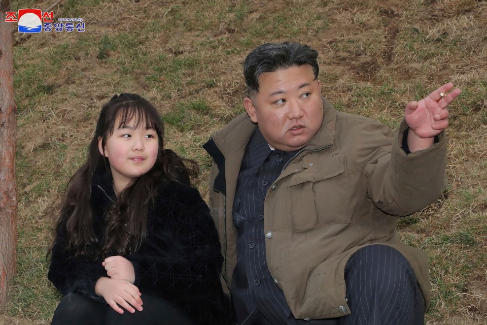 Kim and his daughter watching the launch on Thursday