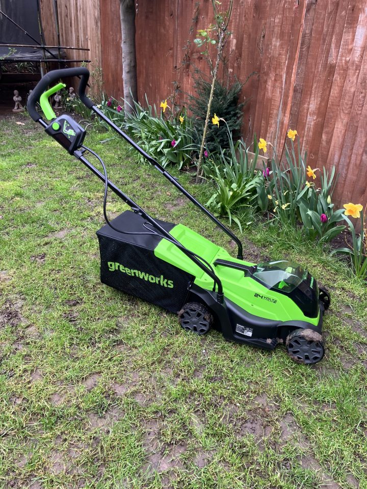 Greenworks 24-volt electric lawnmower on grass.