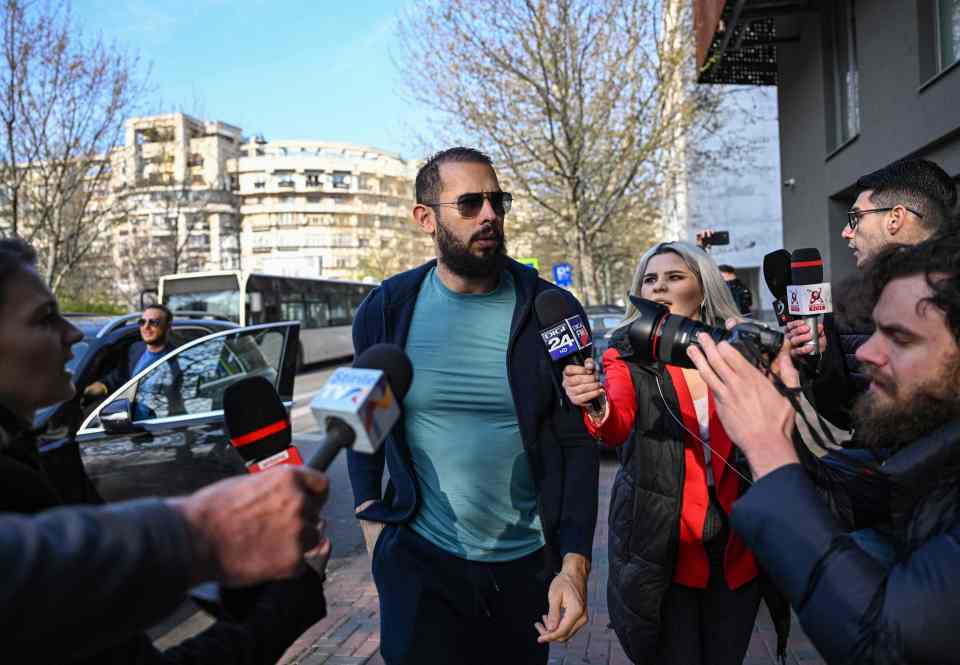 Andrew Tate pictured arriving to face a grilling by Romanian prosecutors