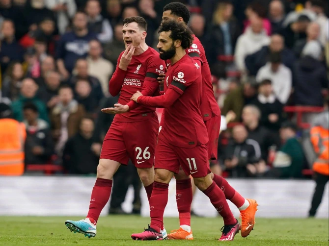 Liverpool star Robertson was holding his jaw as he left the field furious