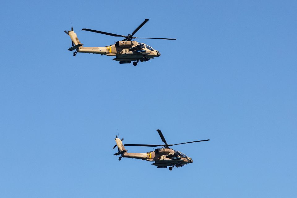 Apache attack helicopters fly over during an air show in Tel Aviv