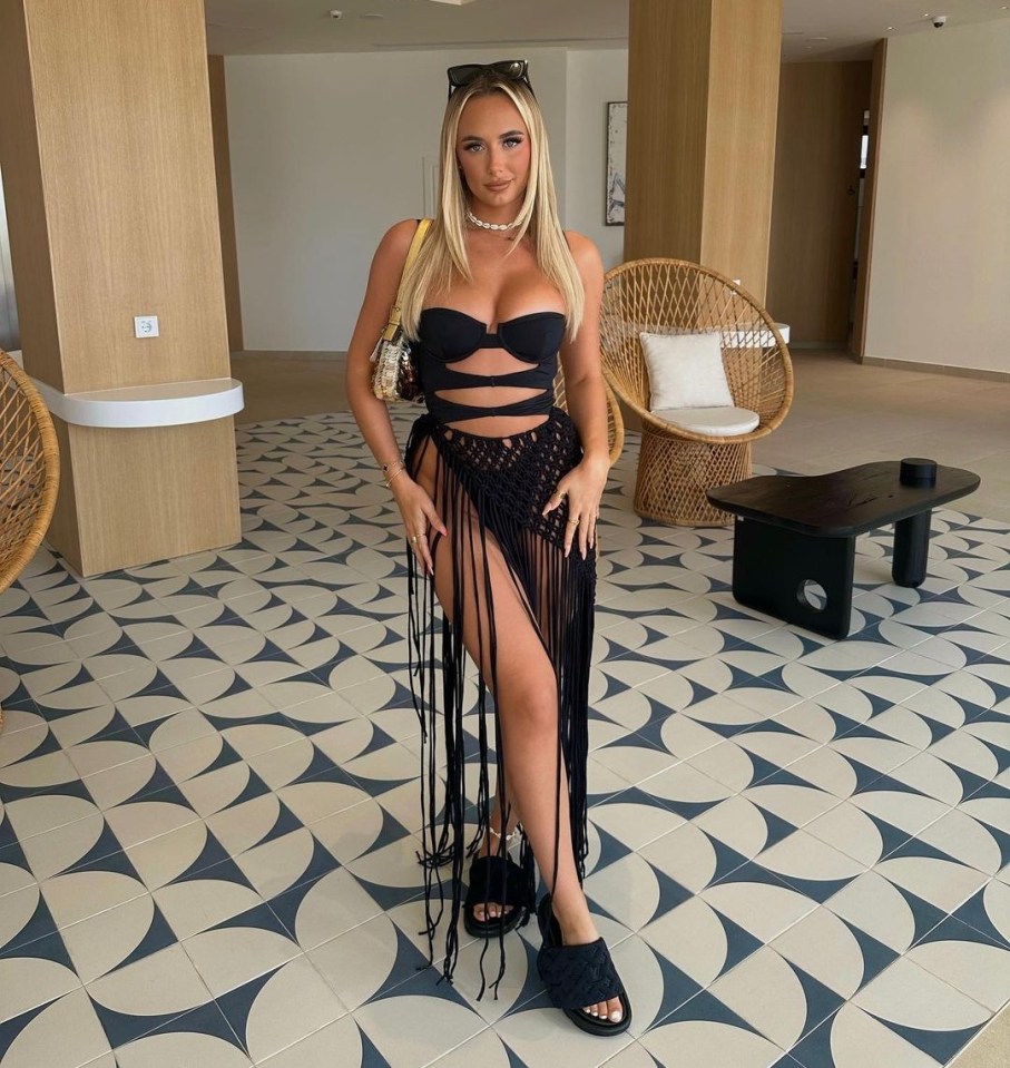 Millie Court showed off her trim figure in a black cut-out swimsuit