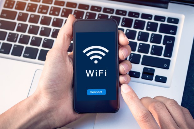 a person holding a cell phone that says wifi on it