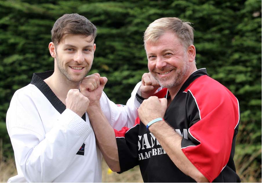 Lee (right) with his son Damon who helps run his martial arts business