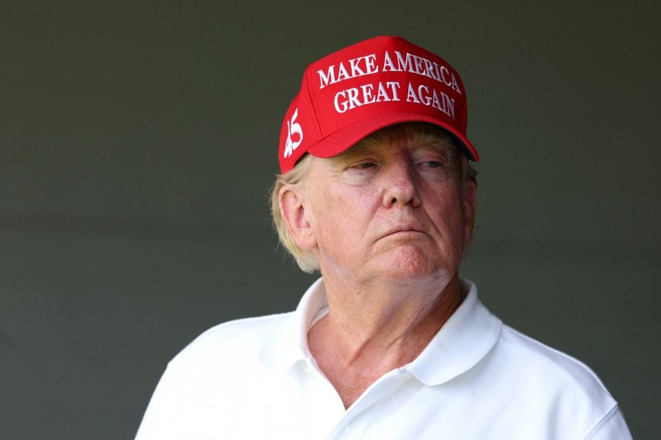STERLING, VIRGINIA - MAY 26: Former US President Donald Trump watches from a box on the 18th green during day one of the LIV Golf Invitational - DC at Trump National Golf Club on May 26, 2023 in Sterling, Virginia. (Photo by Rob Carr/Getty Images)