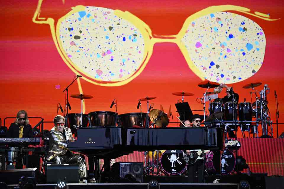 The I’m Still Standing singer wore his trademark huge specs with his suit of gold