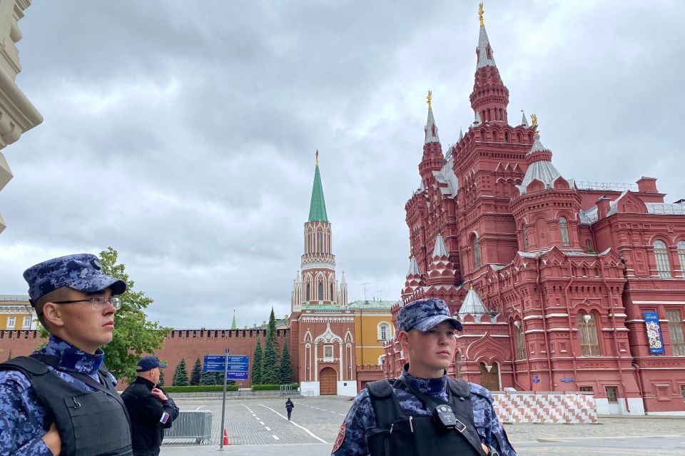 Russian National Guard officers patrol the Kremlin in Moscow as tensions mount