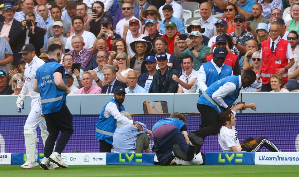 Security staff haul the eco yobs from the field