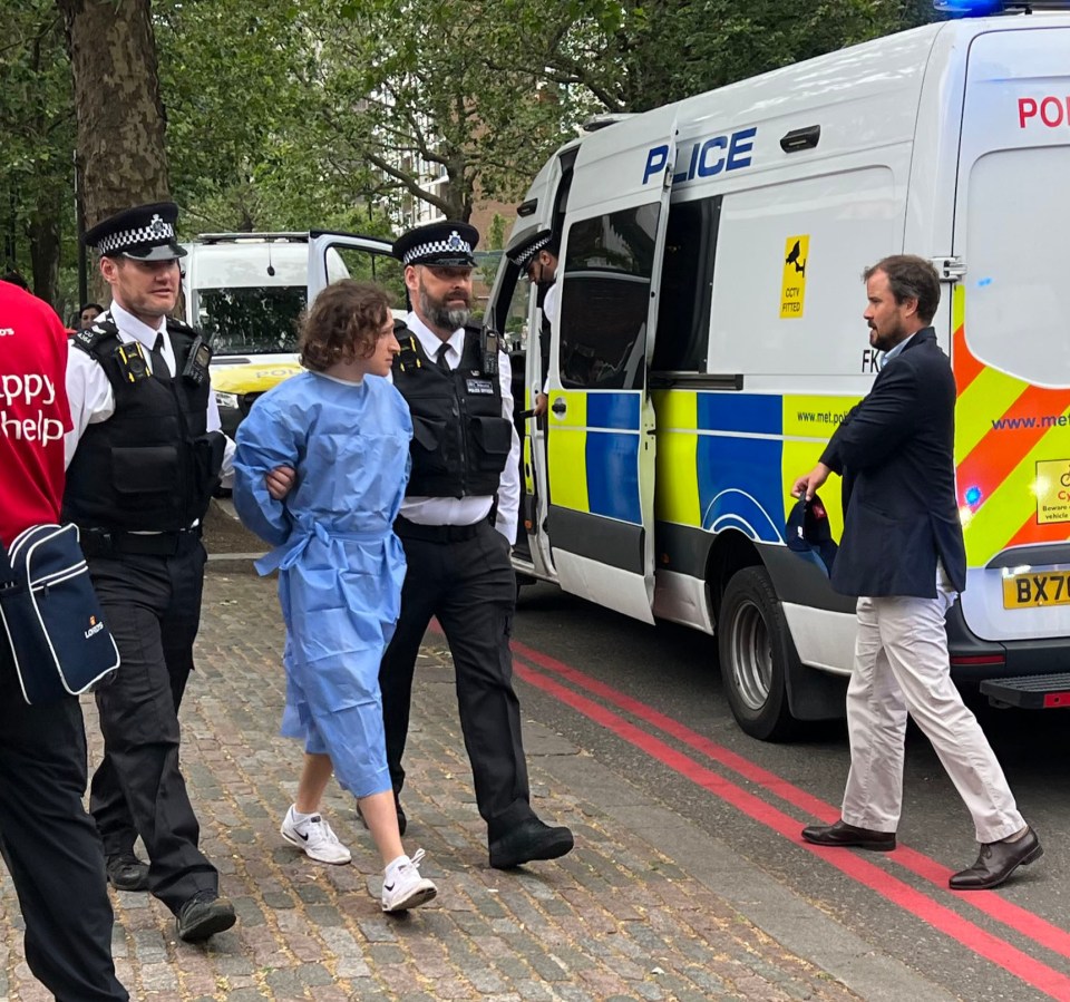 Knorr being taken away from the ground by police