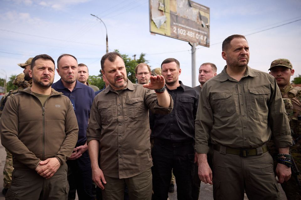 Ukraine's president Volodymyr Zelensky, left, has been visiting residents evacuated from a flooded area in Kherson after the attack on the Kakhovka hydroelectric dam