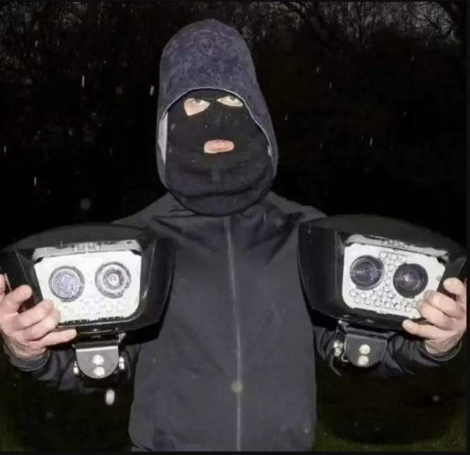 Anti-ULEZ campaigners have been branded 'heroes' by critics of the emission zone after images appearing to show them posing with dismantled cameras surfaced on social media., , Uploaded to the Facebook group 'Action Against Unfair ULEZ CAZ & LTN', images show two balaclava clad vigilantes grasping four dismantled cameras - one held aloft in each hand., , The first in the series of images shows the two figures standing in the rain