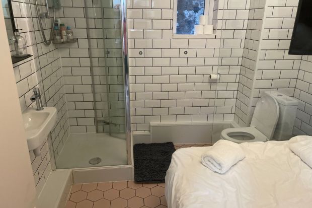 An Airbnb rental in London has the bed in the bathroom