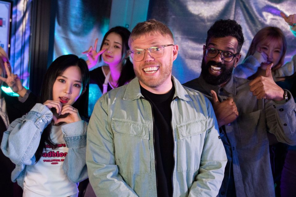 Rob Romesh with a K-pop group.