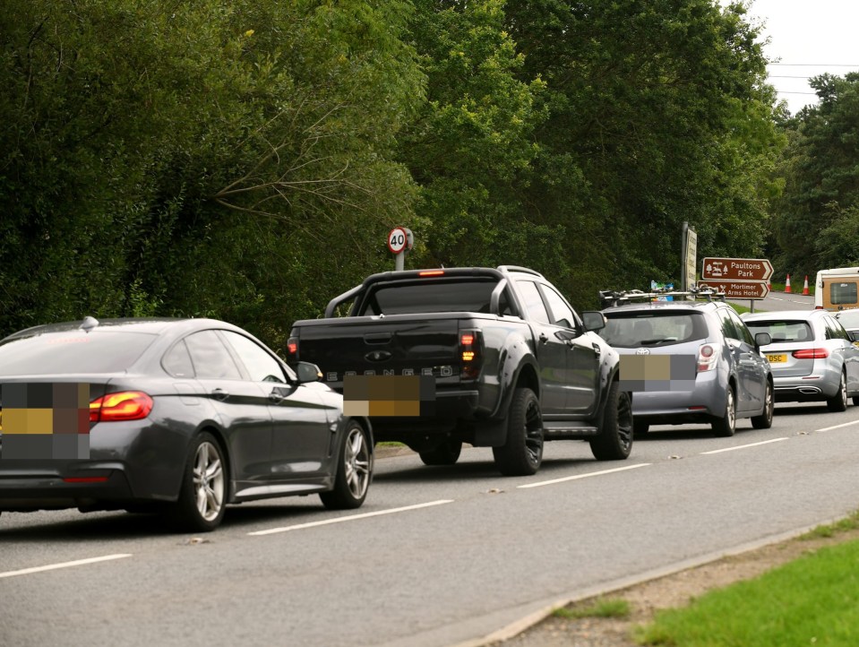 Rows of cars queue to get into the site