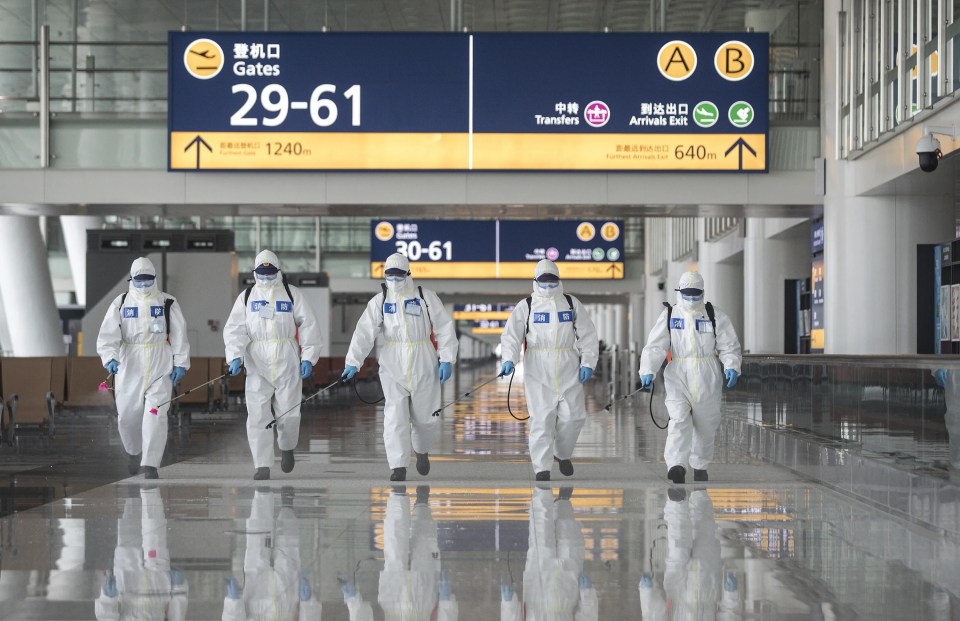 Chinese firefighters disinfect a train station during the outbreak