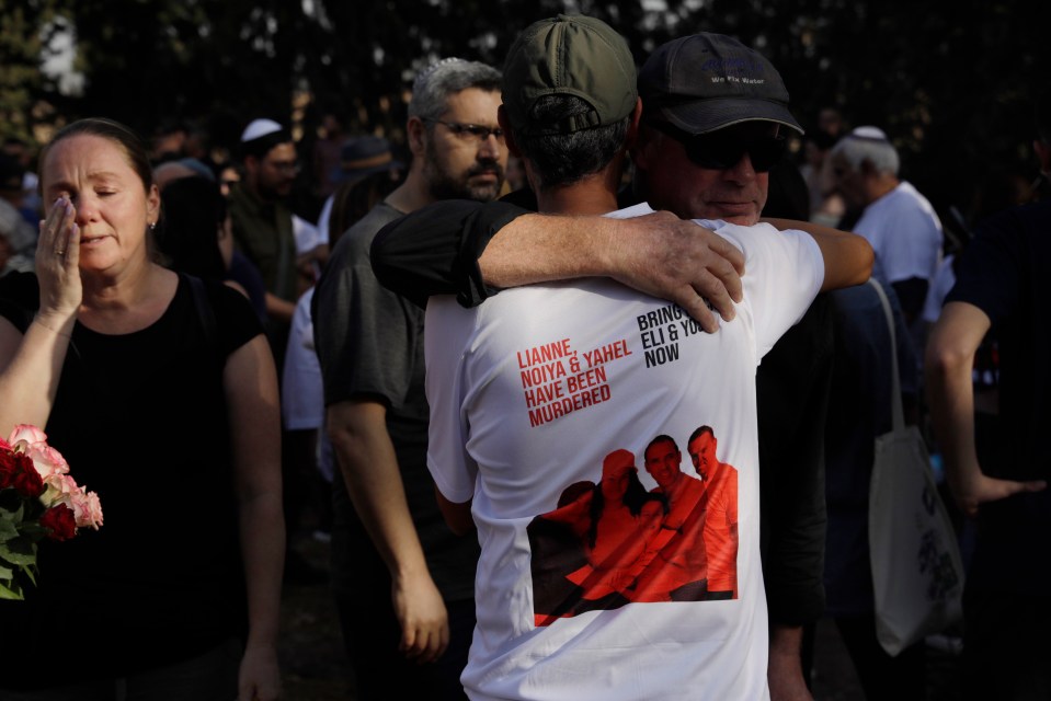 Mourners at the funeral for members of the Sharabi family, who were killed in the attack on Kibbutz Be'eri