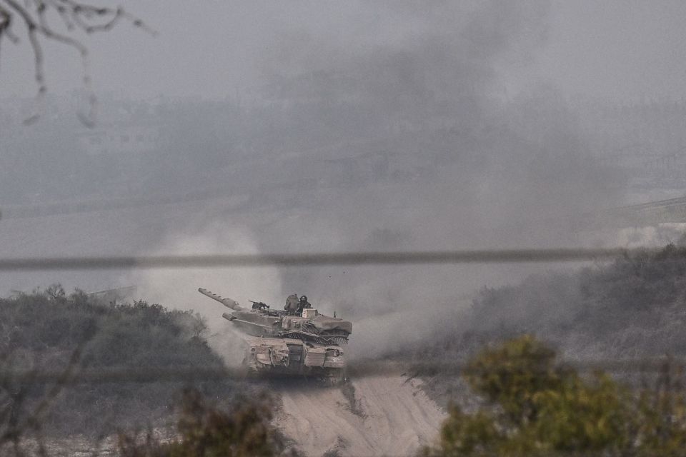 Tanks roll near Gaza as dawn broke following the attack last night