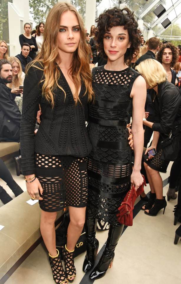 LONDON, ENGLAND - SEPTEMBER 21: Cara Delevingne (L) and St Vincent attend the Burberry Womenswear Spring/Summer 2016 show during London Fashion Week at Kensington Gardens on September 21, 2015 in London, England. (Photo by David M. Benett/Dave Benett/Getty Images for Burberry)