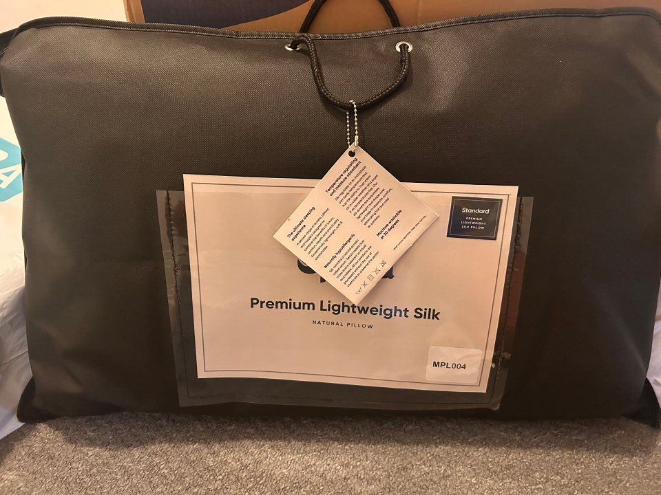 A premium lightweight silk natural pillow on a bed.