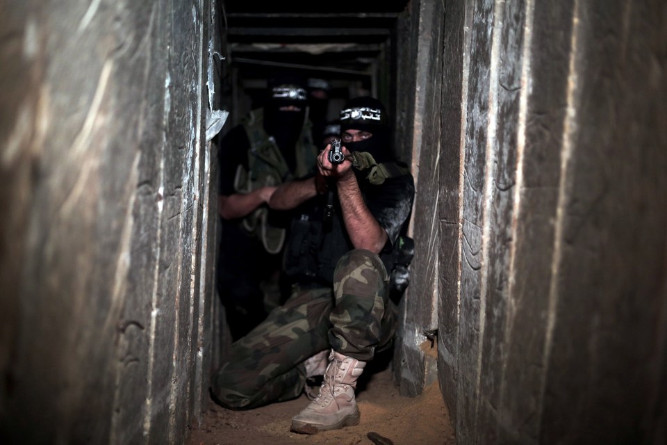 Armed Hamas fighters in a tunnel.