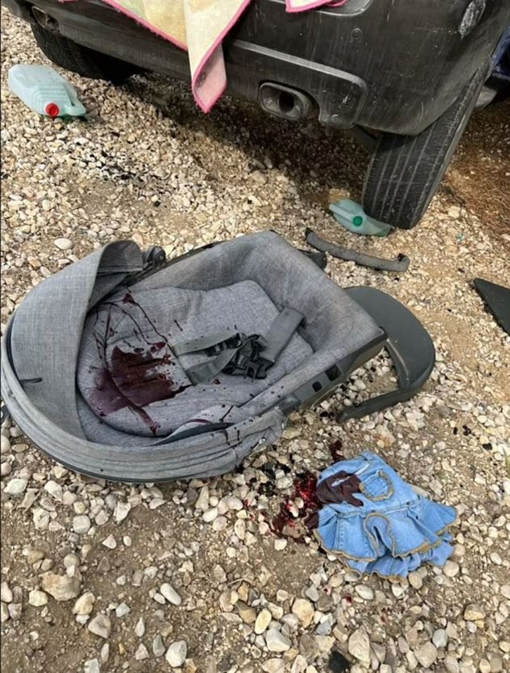 A baby's car seat and child's dress covered in blood in the aftermath of the horrific Hamas attack on October 7