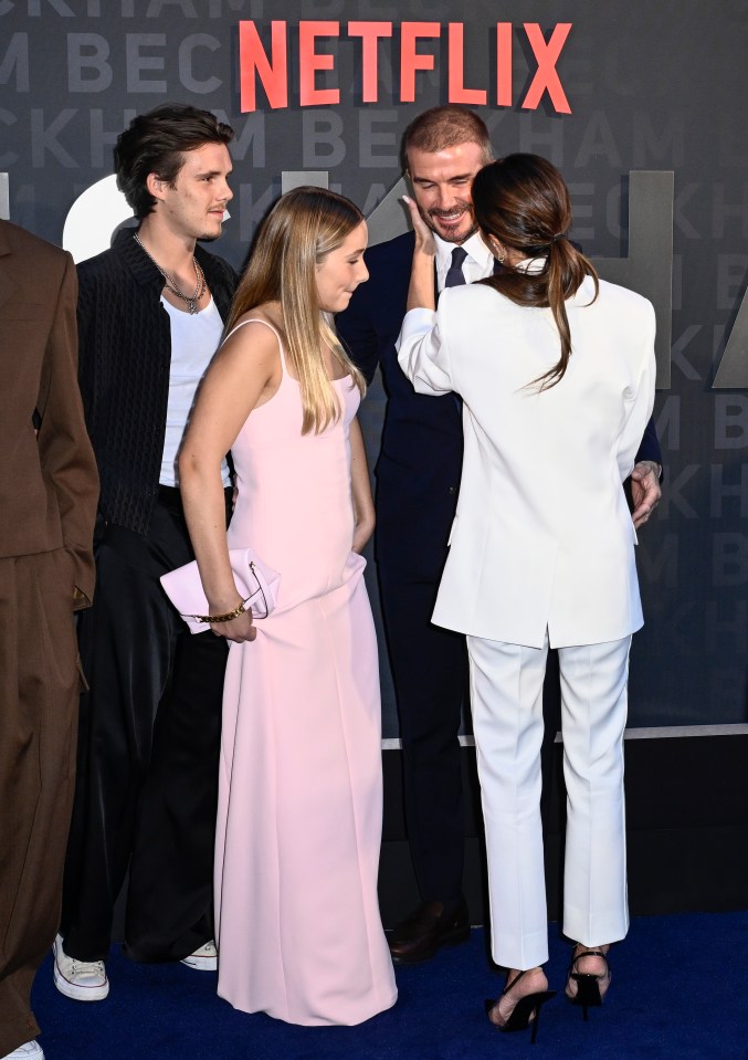 Victoria also cradled her husband's cheek as their family crowded round
