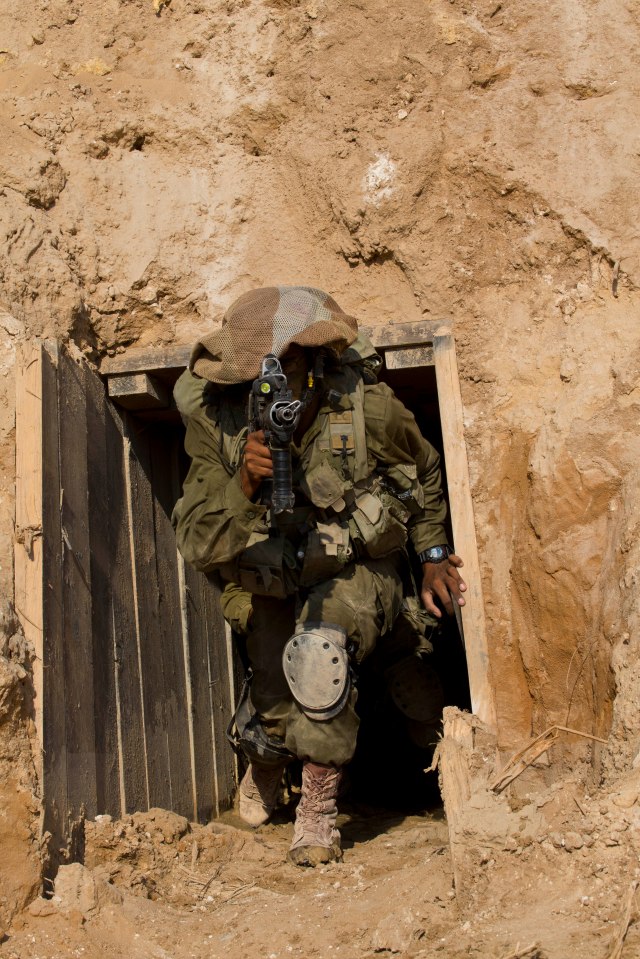 An Israeli soldier guards an entrance to Hamas's terror tunnels underneath the Israel-Gaza border in 2014