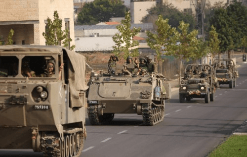 Israeli tanks and troops move near the border with Gaza