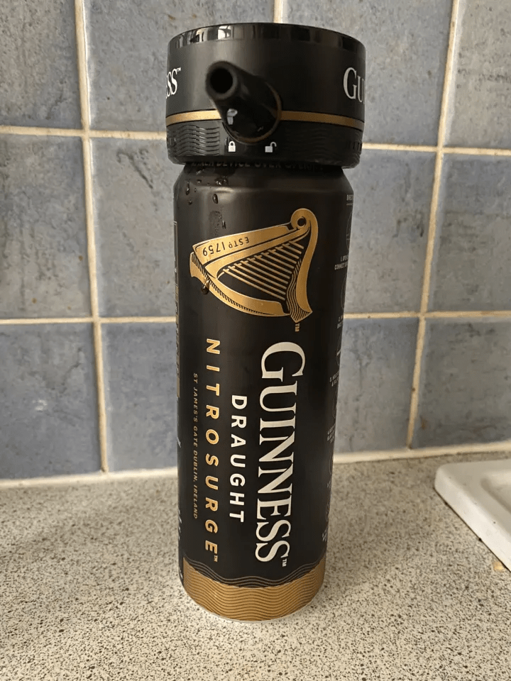 Guinness Nitro Surge can with attached drinking straw.