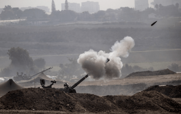 Smoke rises as Israeli forces fire artillery shells on Gaza in Sderot