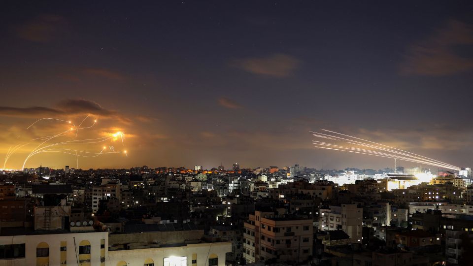 Rockets fired from Gaza City, right, being intercepted by Israel's Iron Dome defence missile system, left