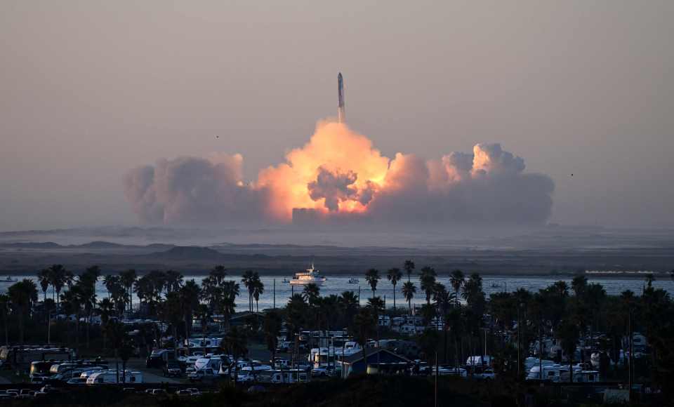a rocket is being launched into the sky over a campground