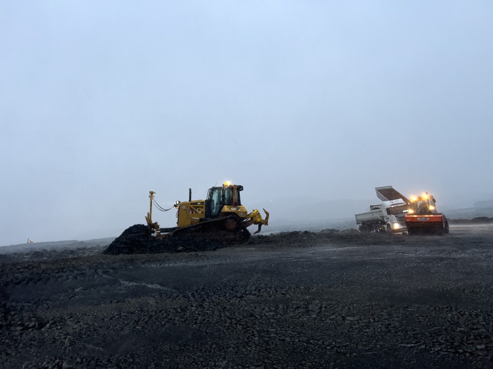 Workers create a wall to protect the power plant and the Blue Lagoon in Grindavik