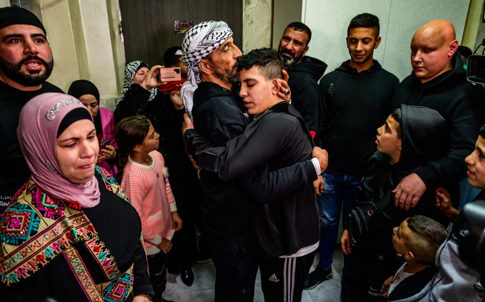 Ahmad Salaima, a 14-year-old Palestinian released under an extended truce deal, embraces his family