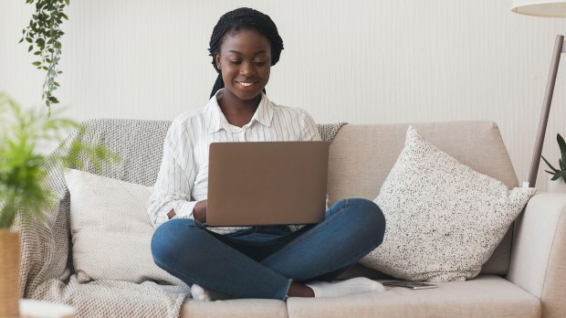woman smiling at her laptop. good wifi