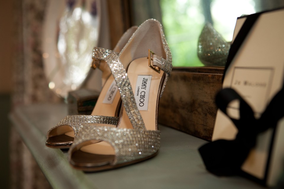 a pair of jimmy choo shoes sitting on a shelf